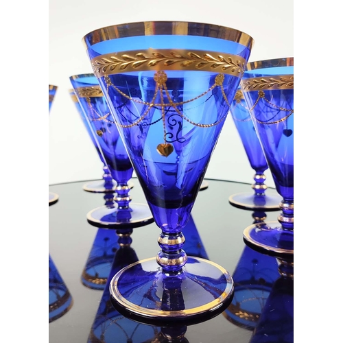 30 - A SET OF VENETIAN COBALT BLUE AND GOLD HAND PAINTED GLASSES, seven champagne coupes, nine martini gl... 