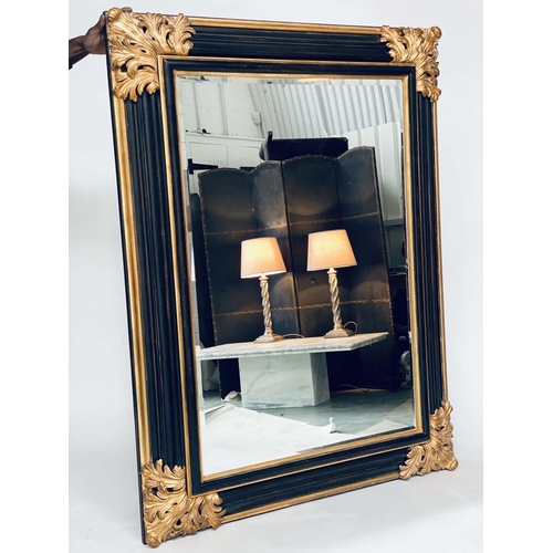 106 - WALL MIRROR, Italian style ebonised and parcel gilt with bevelled mirror and bold acanthus spandrels... 