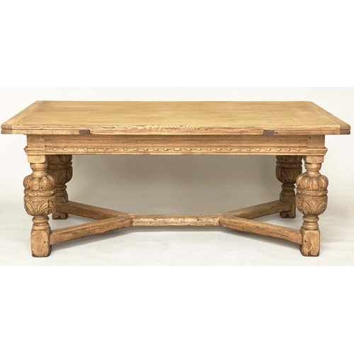 114 - DRAWLEAF EXTENDING DINING TABLE, English style oak, with notch carved frieze raised on broad carved ... 