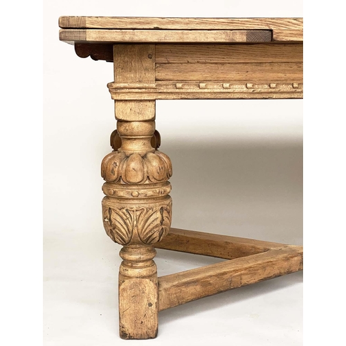 114 - DRAWLEAF EXTENDING DINING TABLE, English style oak, with notch carved frieze raised on broad carved ... 