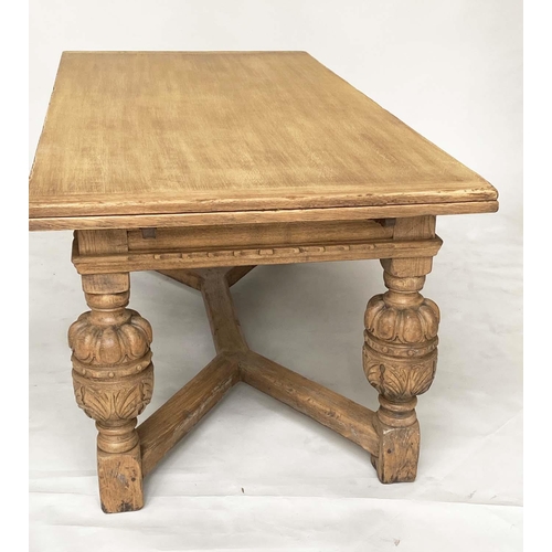 114 - DRAWLEAF EXTENDING DINING TABLE, English style oak, with notch carved frieze raised on broad carved ... 