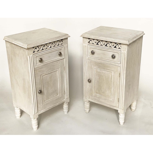 116 - BEDSIDE CABINETS, a pair, French traditionally grey painted with drawer, panelled door and pierced f... 