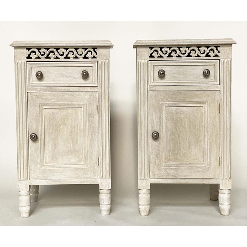 116 - BEDSIDE CABINETS, a pair, French traditionally grey painted with drawer, panelled door and pierced f... 