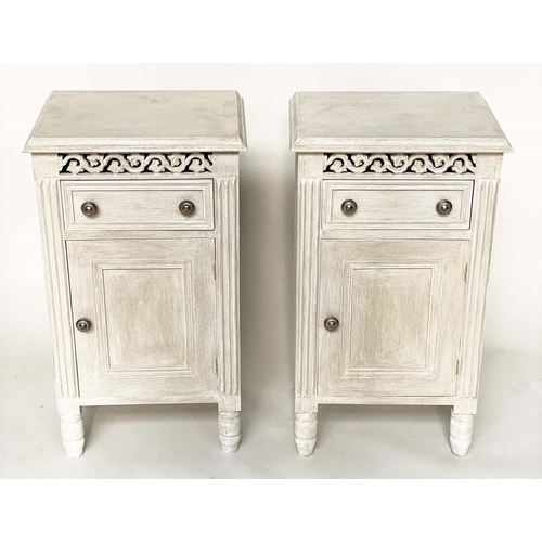 116 - BEDSIDE CABINETS, a pair, French traditionally grey painted with drawer, panelled door and pierced f... 