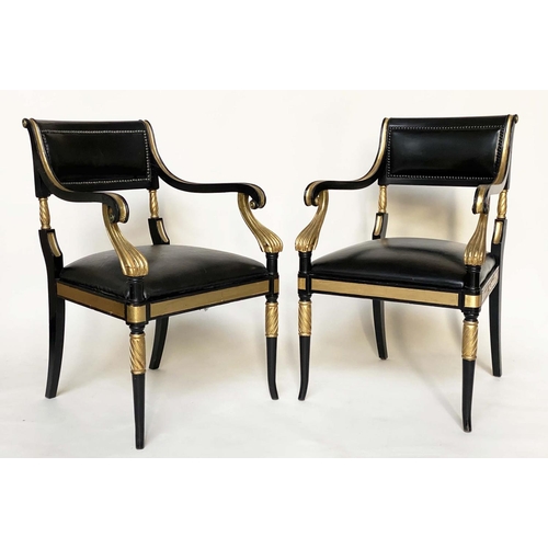 97 - ARMCHAIRS, a pair, Regency style lacquered and gilded with leather seats scroll arms and swept front... 