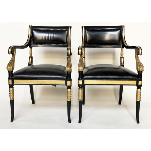 97 - ARMCHAIRS, a pair, Regency style lacquered and gilded with leather seats scroll arms and swept front... 