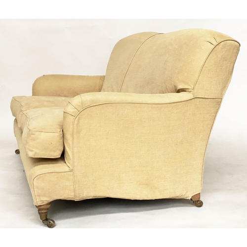 85 - SOFA, Howard style with rounded backs and arms and shaped sides with close fitting yellow linen loos... 