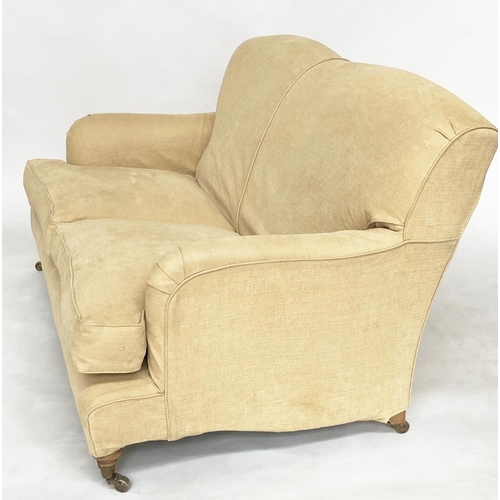 85 - SOFA, Howard style with rounded backs and arms and shaped sides with close fitting yellow linen loos... 