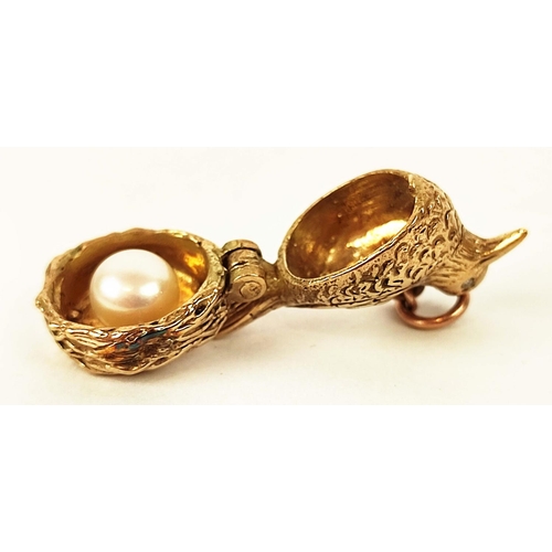 21 - A 9CT GOLD CHARM IN THE FORM OF A HEN WITH DIAMOND EYES, opening to reveal a nesting an egg, formed ... 