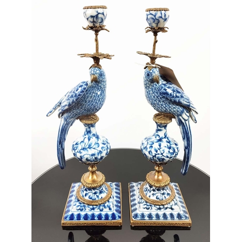 597 - CANDELABRA, a pair, in the form of parrots, blue and white ceramic, gilt mounts, 48.5cm H. (2)