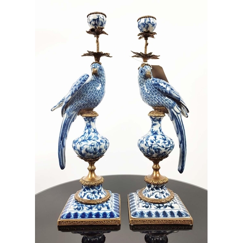 597 - CANDELABRA, a pair, in the form of parrots, blue and white ceramic, gilt mounts, 48.5cm H. (2)