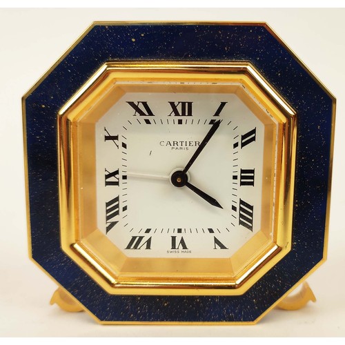 65 - A CARTIER TRAVELLING CLOCK, simulated lapis lazuli enameled gilt octagonal case, white dial with Rom... 