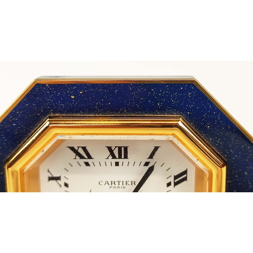 65 - A CARTIER TRAVELLING CLOCK, simulated lapis lazuli enameled gilt octagonal case, white dial with Rom... 