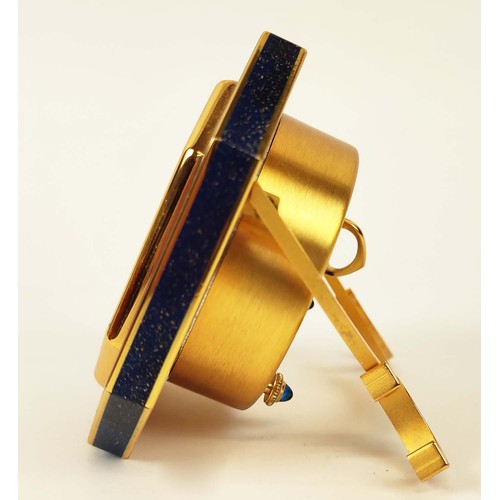 65 - A CARTIER TRAVELLING CLOCK, simulated lapis lazuli enameled gilt octagonal case, white dial with Rom... 