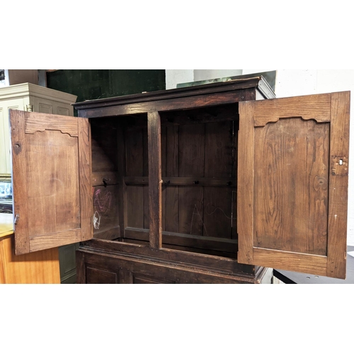 189 - PRESS CUPBOARD, 140cm W x 53cm D x 188cm H, early 18th century oak, with a pair of panelled doors en... 