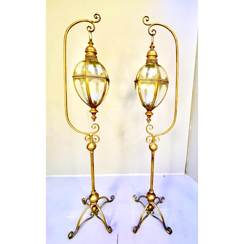 362 - STORM LANTERNS ON STANDS, a pair, 163cm high, 35cm wide, 30cm deep, Regency style, gilt metal. (2)