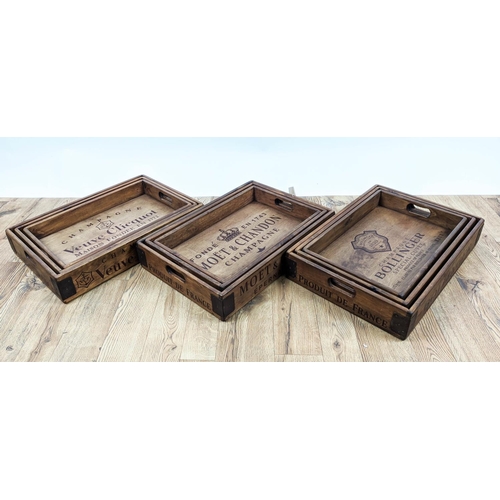 305 - DRINKS TRAYS, three graduated sets of three, stamped with various champagne houses, 56cm x 38cm x 95... 