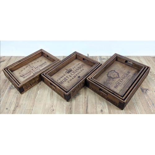 305 - DRINKS TRAYS, three graduated sets of three, stamped with various champagne houses, 56cm x 38cm x 95... 