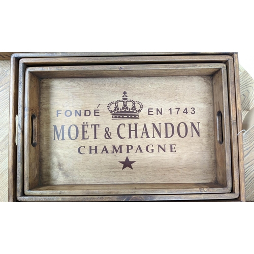 305 - DRINKS TRAYS, three graduated sets of three, stamped with various champagne houses, 56cm x 38cm x 95... 