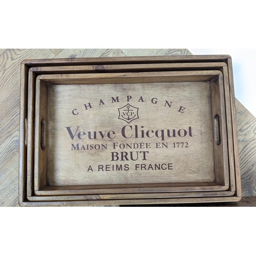 305 - DRINKS TRAYS, three graduated sets of three, stamped with various champagne houses, 56cm x 38cm x 95... 