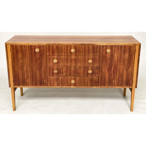 281 - GORDON RUSSELL SIDEBOARD, 1970s Indian Laurel with four centre drawers flanked by doors enclosing sh... 