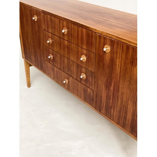 281 - GORDON RUSSELL SIDEBOARD, 1970s Indian Laurel with four centre drawers flanked by doors enclosing sh... 