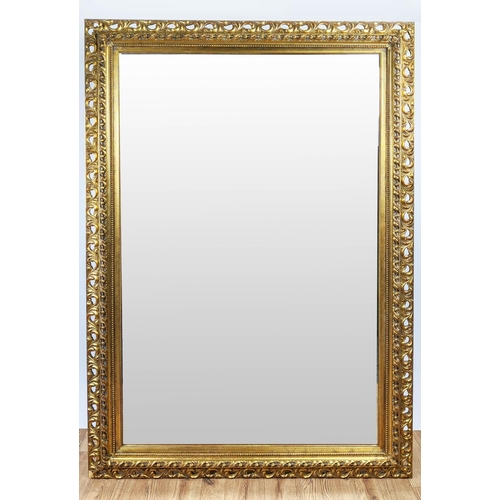 414 - WALL MIRROR, 185cm x 125cm, with a decorative pierced frame and bevelled plate.