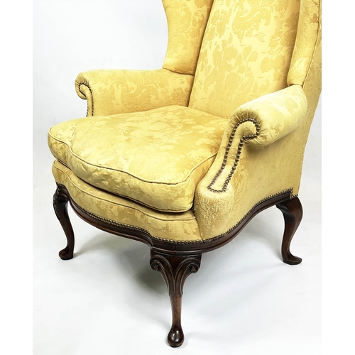 107 - WING ARMCHAIR, 112cm H x 98cm W, Queen Anne style, walnut, in yellow fabric.