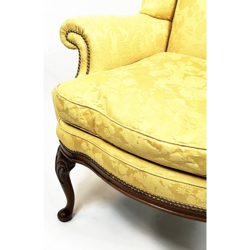 107 - WING ARMCHAIR, 112cm H x 98cm W, Queen Anne style, walnut, in yellow fabric.