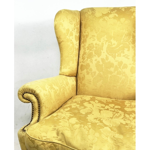 107 - WING ARMCHAIR, 112cm H x 98cm W, Queen Anne style, walnut, in yellow fabric.