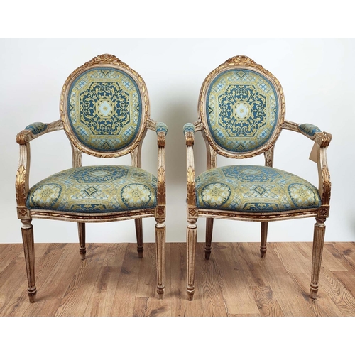 192 - FAUTEUILS, a pair, each 60cm x 101cm H, Louis XVI style with carved showframes and gilt detail in Ve... 