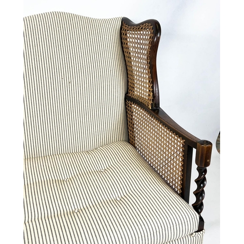 199 - BERGERE WING SOFA, 99cm H x 117cm W, circa 1920, walnut, with  caned arms and ticking upholstery.