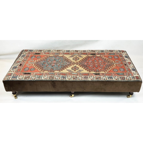 200 - HEARTH STOOL, 33cm H x 168cm W x 83cm D, carpet and brown velvet upholstered, on brass castors.