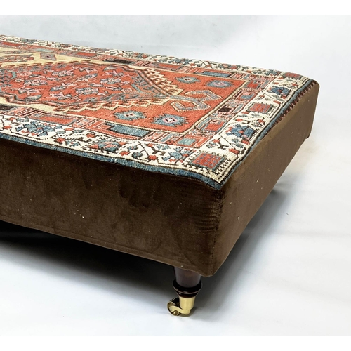 200 - HEARTH STOOL, 33cm H x 168cm W x 83cm D, carpet and brown velvet upholstered, on brass castors.