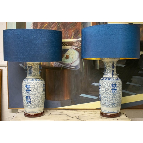 218 - TABLE LAMPS, 92cm H x 61cm, a pair, Chinese blue and white ceramic with blue shades. (2) (loose fitt... 