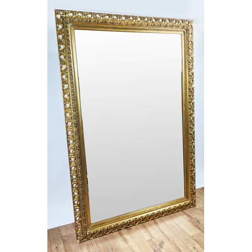 414 - WALL MIRROR, 185cm x 125cm, with a decorative pierced frame and bevelled plate.