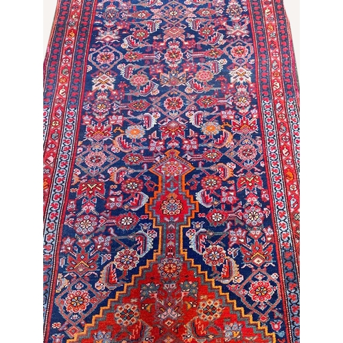 89 - ANTIQUE NORTH WEST PERSIAN RUNNER, 490cm x 103cm.