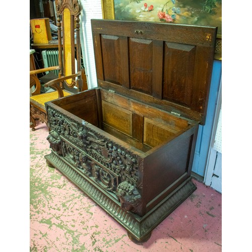 242 - COFFER, 64cm H x 124cm x 64cm, Victorian oak with hinged top and heavily carved front.