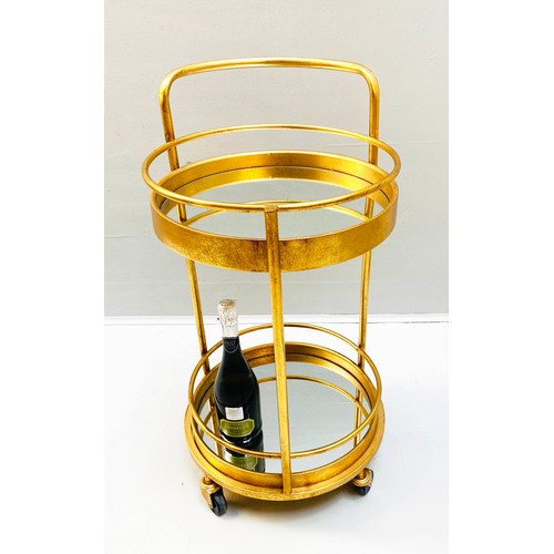 355 - COCKTAIL TROLLEY, 77cm high, 42cm diameter, 1960s French style, mirrored glass tiers, gilt metal fra... 