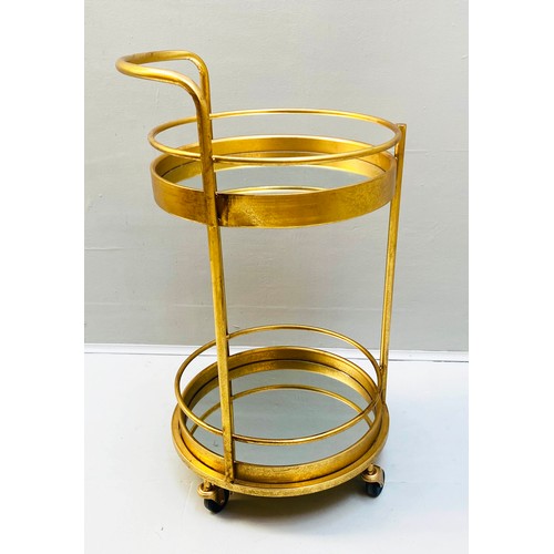 355 - COCKTAIL TROLLEY, 77cm high, 42cm diameter, 1960s French style, mirrored glass tiers, gilt metal fra... 