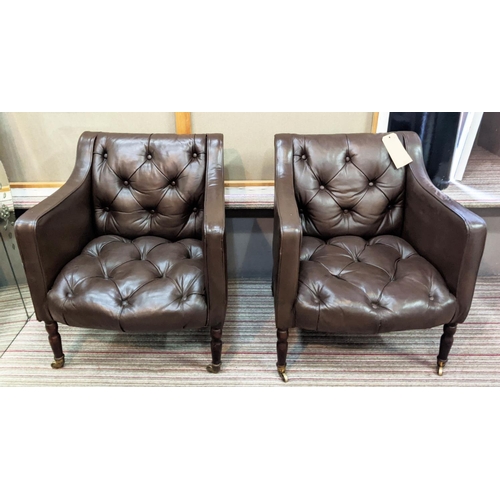 254 - CLUB ARMCHAIRS, a pair, each 65cm W x 75cm H, in buttoned brown leather on turned supports, Provenan... 