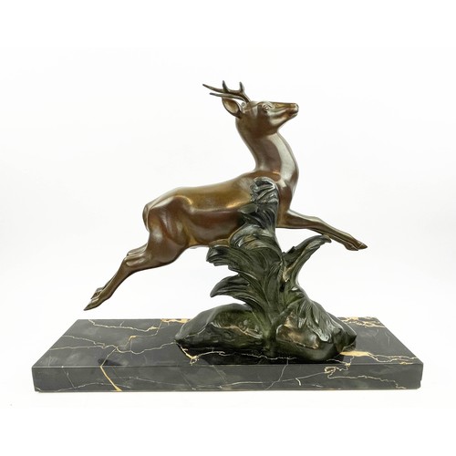 29 - A SOLEALL BRONZE DEER, Art Deco on black variegated marble base, 52cm L x 41cm H.