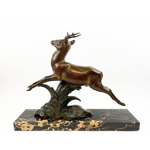 29 - A SOLEALL BRONZE DEER, Art Deco on black variegated marble base, 52cm L x 41cm H.