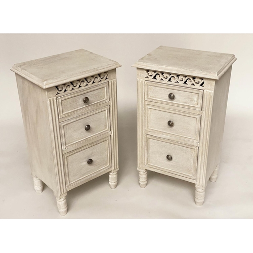 114 - BEDSIDE CHESTS, a pair, French style grey painted each with three drawers and pierced frieze, 40cm x... 