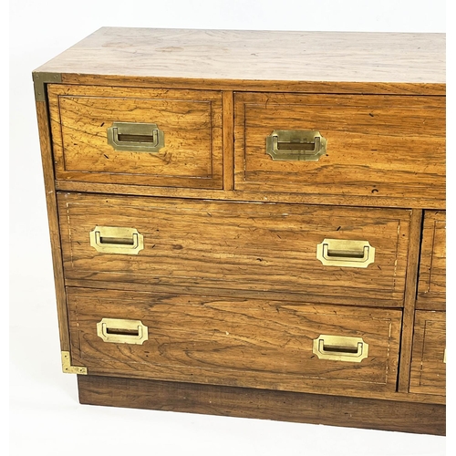 126 - LOW CHEST, campaign style with an arrangement of seven drawers, 74cm H x 143cm W x 46cm D.