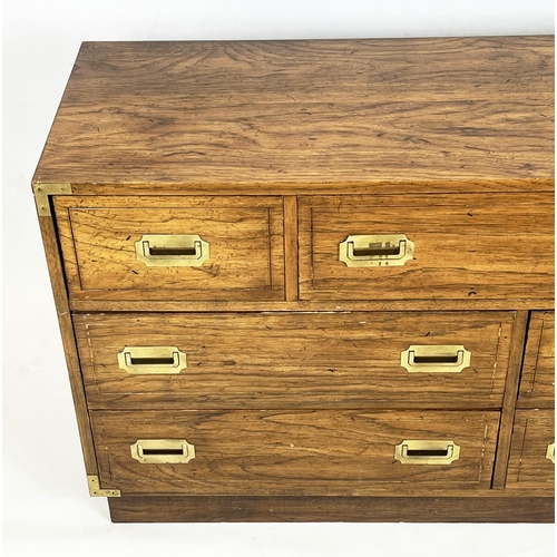 126 - LOW CHEST, campaign style with an arrangement of seven drawers, 74cm H x 143cm W x 46cm D.