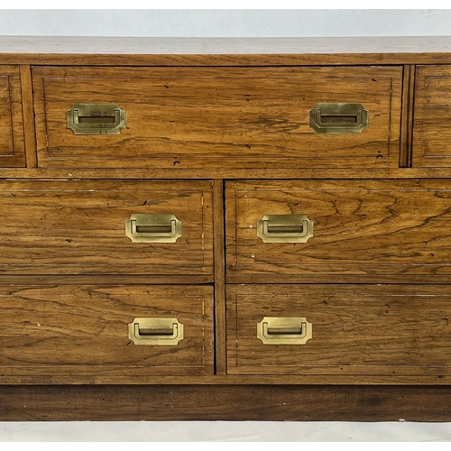 126 - LOW CHEST, campaign style with an arrangement of seven drawers, 74cm H x 143cm W x 46cm D.