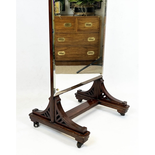 127 - CHEVAL MIRROR, late 19th century mahogany with a bevelled plate, raised on brass castors, 188cm H x ... 