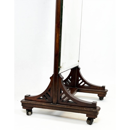 127 - CHEVAL MIRROR, late 19th century mahogany with a bevelled plate, raised on brass castors, 188cm H x ... 