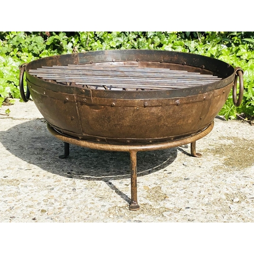 395 - INDIAN STYLE KADAI FIRE PIT, on a stand, oxidised metal, 47cm high, 64cm wide, 60cm diameter.